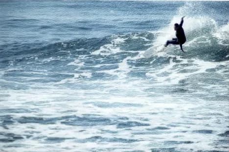 A surfer on a big wave in the sea.